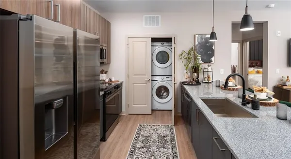 a kitchen with a table chairs and refrigerator
