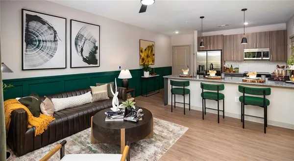 a living room with furniture a flat screen tv and a large window