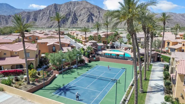 an aerial view of a house with a garden and lake view