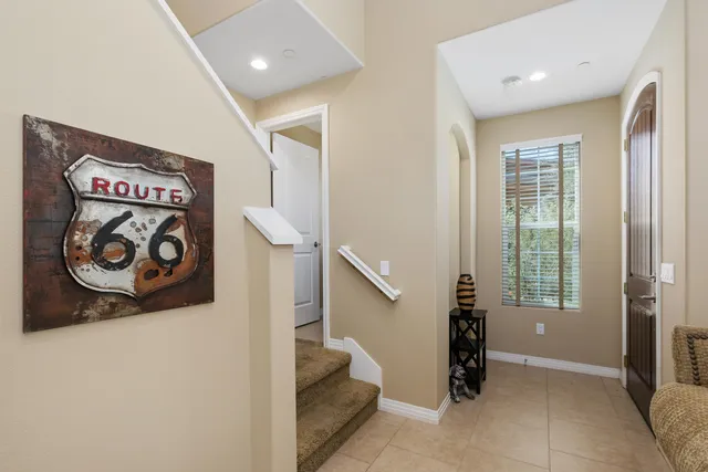 a bathroom with a granite countertop toilet sink and mirror