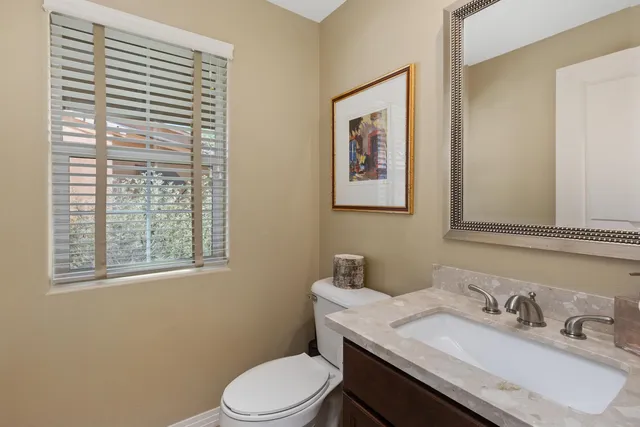 a view of a hallway with a livingroom and a livingroom with furniture