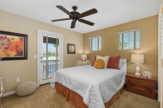 a bedroom with a bed and a painting on the wall