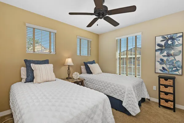 a bedroom with two beds and a window