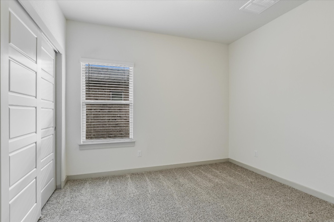 5125 Vanner Path Georgetown, TX 78626 - Photo 21 of 27 Unfurnished bedroom with a closet and light carpet