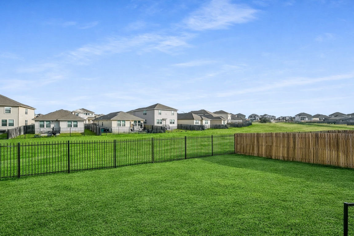 5125 Vanner Path Georgetown, TX 78626 - Photo 24 of 27 Fenced backyard with a residential view. Digitally Enhanced.