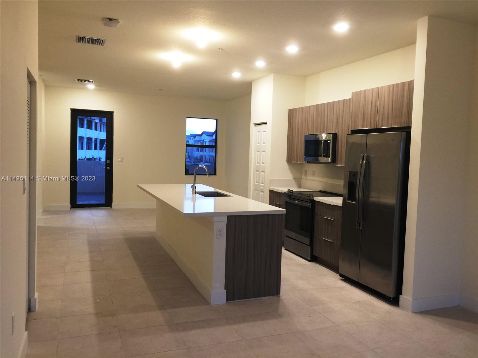 Doral Doral, FL 33178 - Photo 4 of 18 a kitchen with stainless steel appliances kitchen island granite countertop a refrigerator and a sink