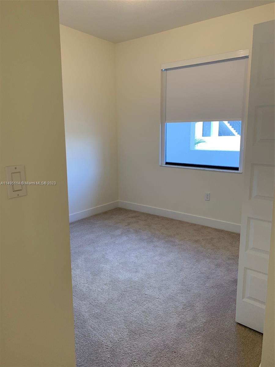 Doral Doral, FL 33178 - Photo 5 of 18 a view of a small space with a wooden floor and a window