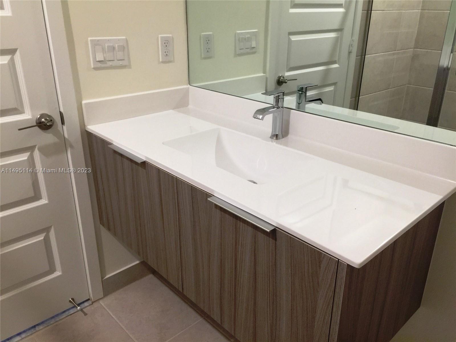 Doral Doral, FL 33178 - Photo 8 of 18 a bathroom with a sink and a mirror