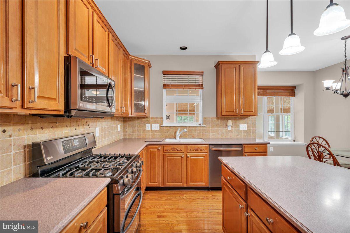 68 Hillside Lane Mount Laurel, NJ 08054 - Photo 10 of 36 a kitchen with stainless steel appliances a sink stove and cabinets
