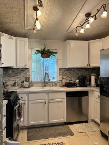 a kitchen with a sink cabinets and appliances