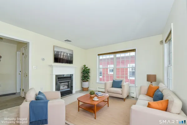 a living room with furniture a window and a fireplace