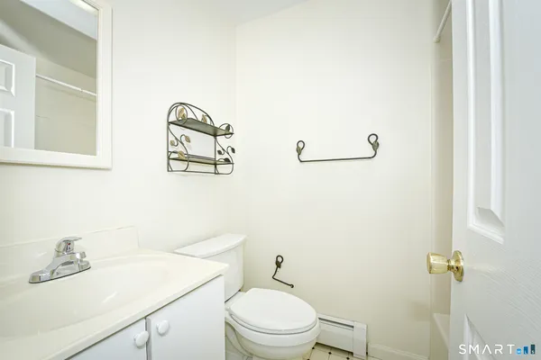 a bathroom with a sink a toilet and mirror