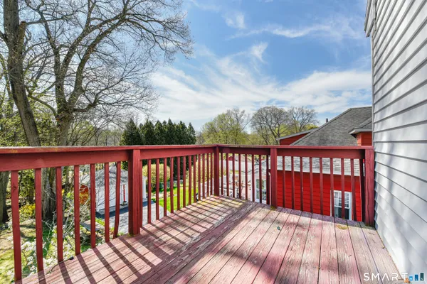 a balcony with wooden floor and fence