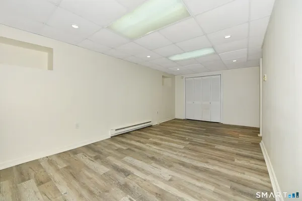 a living room with furniture gym equipment and a chandelier