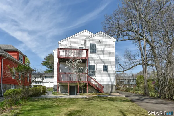 a view of a house with a large tree
