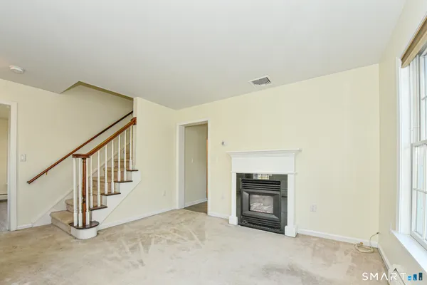 a view of an empty room and fire place