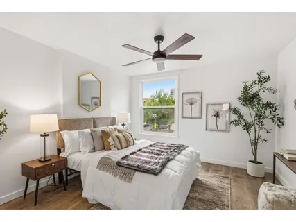 a bedroom with a bed and a potted plant