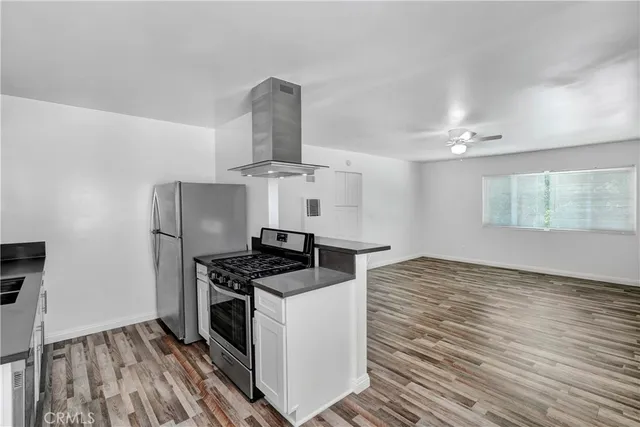 a kitchen with stainless steel appliances a stove a sink and a refrigerator