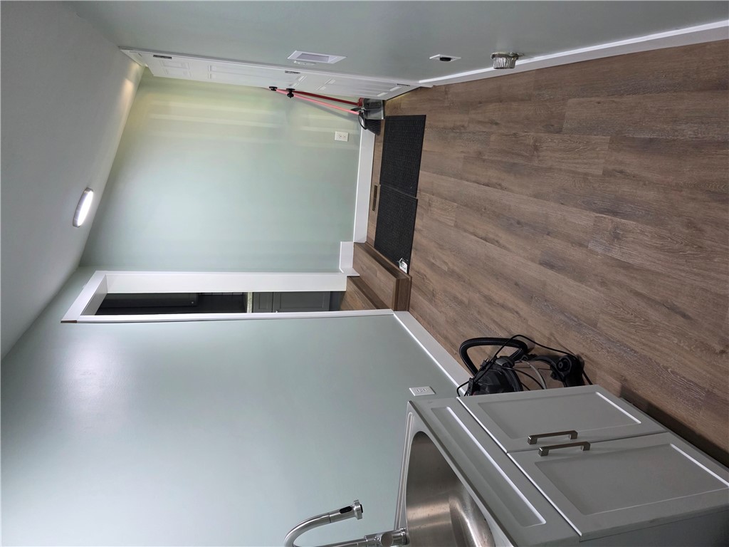 112 Simmons Street Anderson, SC 29625 - Photo 8 of 26 Functional laundry room featuring a utility sink and durable wood flooring.