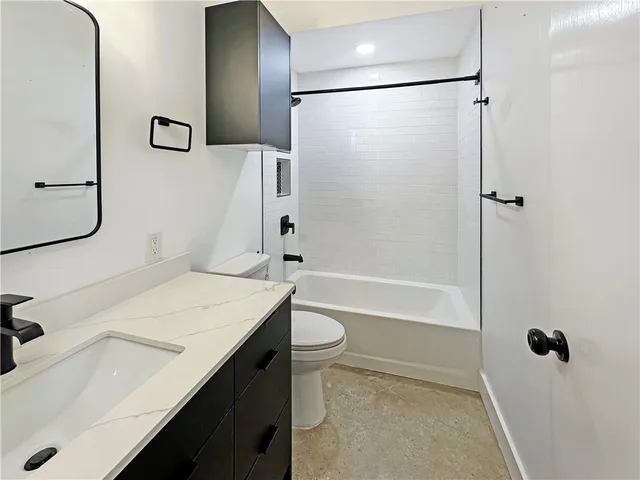 an empty room with ceiling fan and window