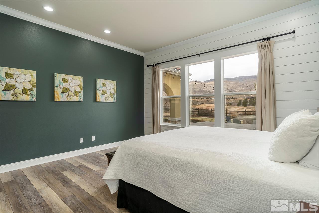 8475 Fairway Chase Trail Reno, NV 89523 - Photo 13 of 40 a bedroom with a large bed and a large window