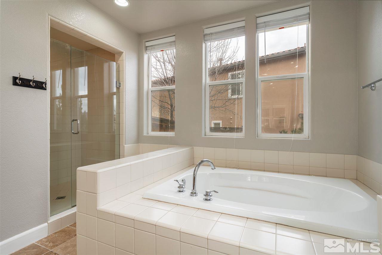 8475 Fairway Chase Trail Reno, NV 89523 - Photo 15 of 40 a bathroom with a bathtub and a shower