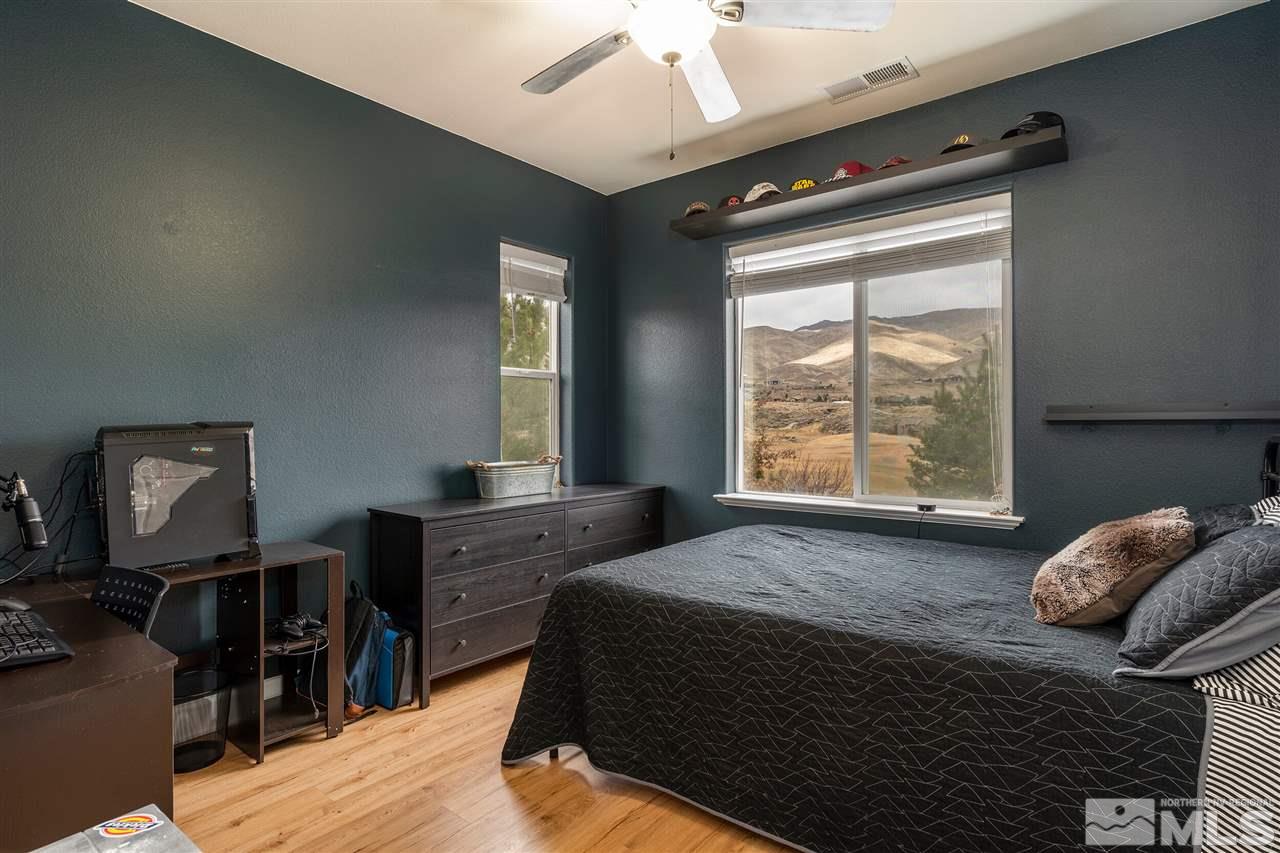 8475 Fairway Chase Trail Reno, NV 89523 - Photo 17 of 40 a bedroom with a bed and wooden floor