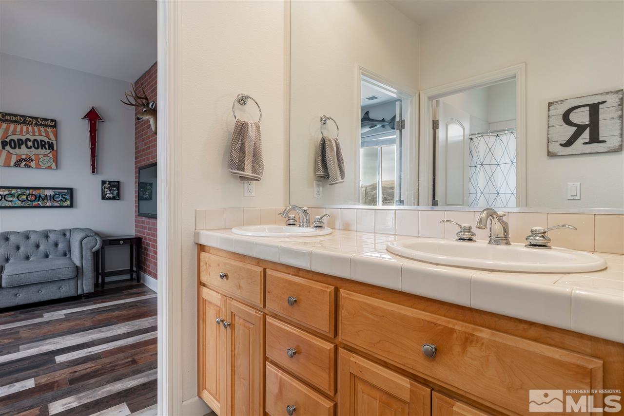 8475 Fairway Chase Trail Reno, NV 89523 - Photo 20 of 40 a bathroom with a double vanity sink and a mirror