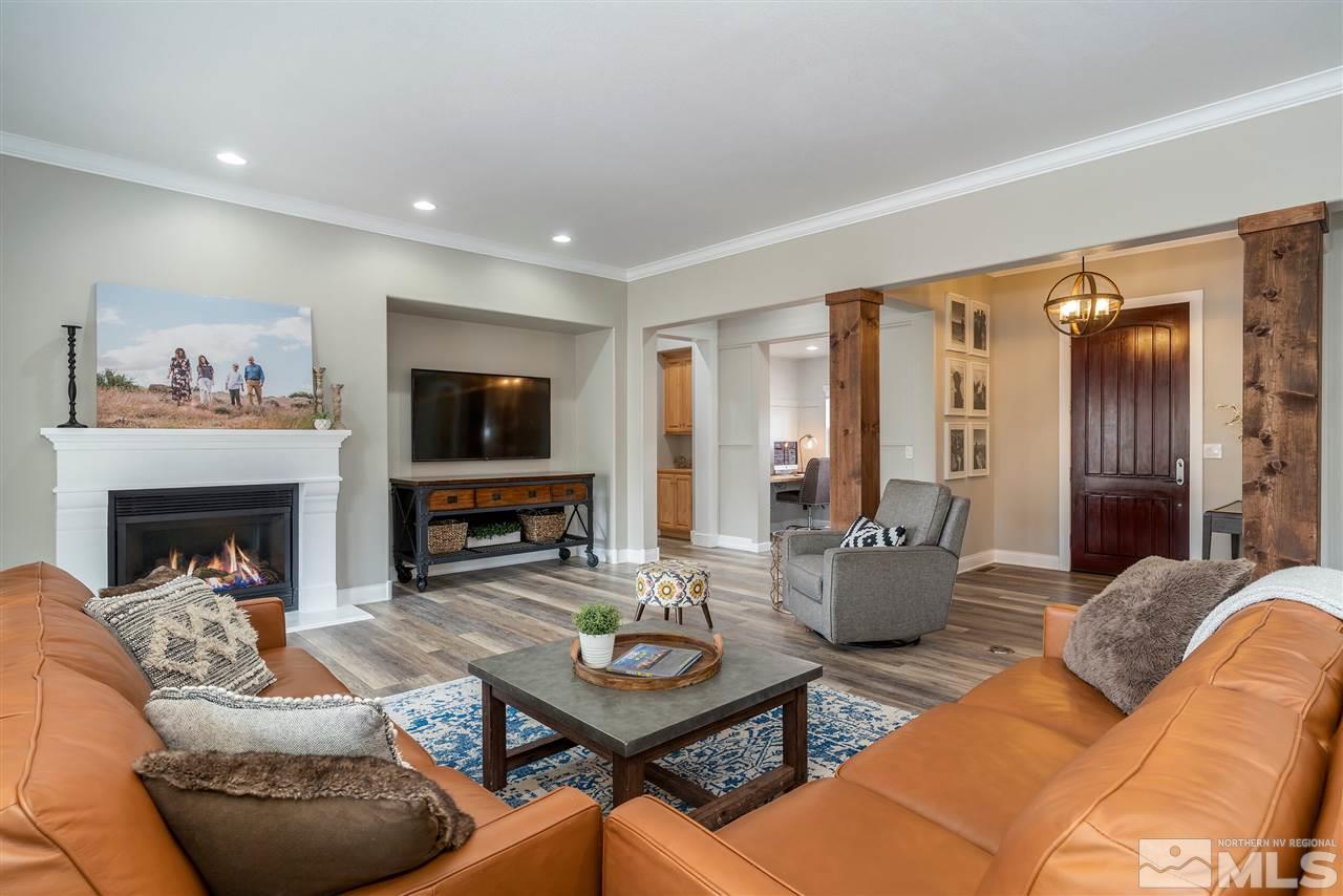 8475 Fairway Chase Trail Reno, NV 89523 - Photo 6 of 40 a living room with furniture a flat screen tv and a fireplace