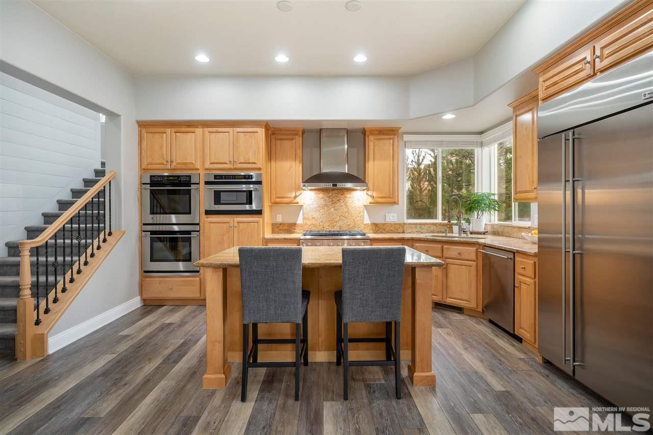 8475 Fairway Chase Trail Reno, NV 89523 - Photo 7 of 40 a dining room with stainless steel appliances granite countertop a kitchen island hardwood floor and a window