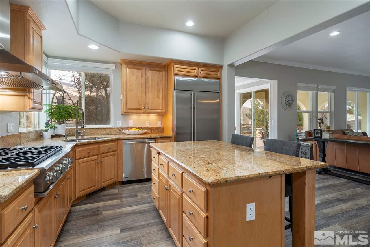8475 Fairway Chase Trail Reno, NV 89523 - Photo 9 of 40 a kitchen with stainless steel appliances granite countertop a stove and a sink