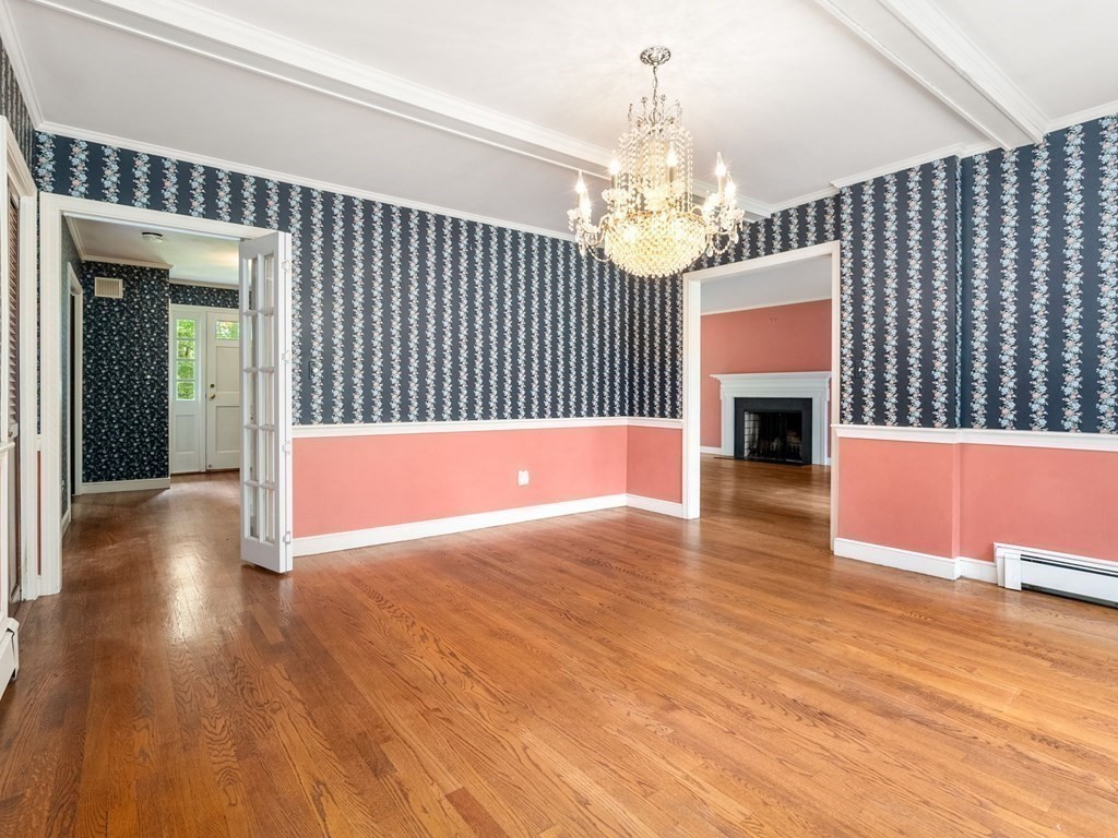 59 Spywood Road Sherborn, MA 01770 - Photo 12 of 40 a view of livingroom with fireplace wooden floor chandelier and windows