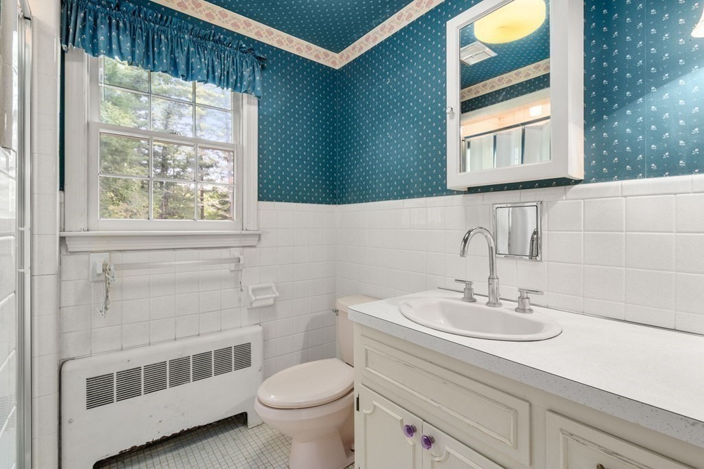 59 Spywood Road Sherborn, MA 01770 - Photo 13 of 40 a bathroom with a sink a toilet and a mirror