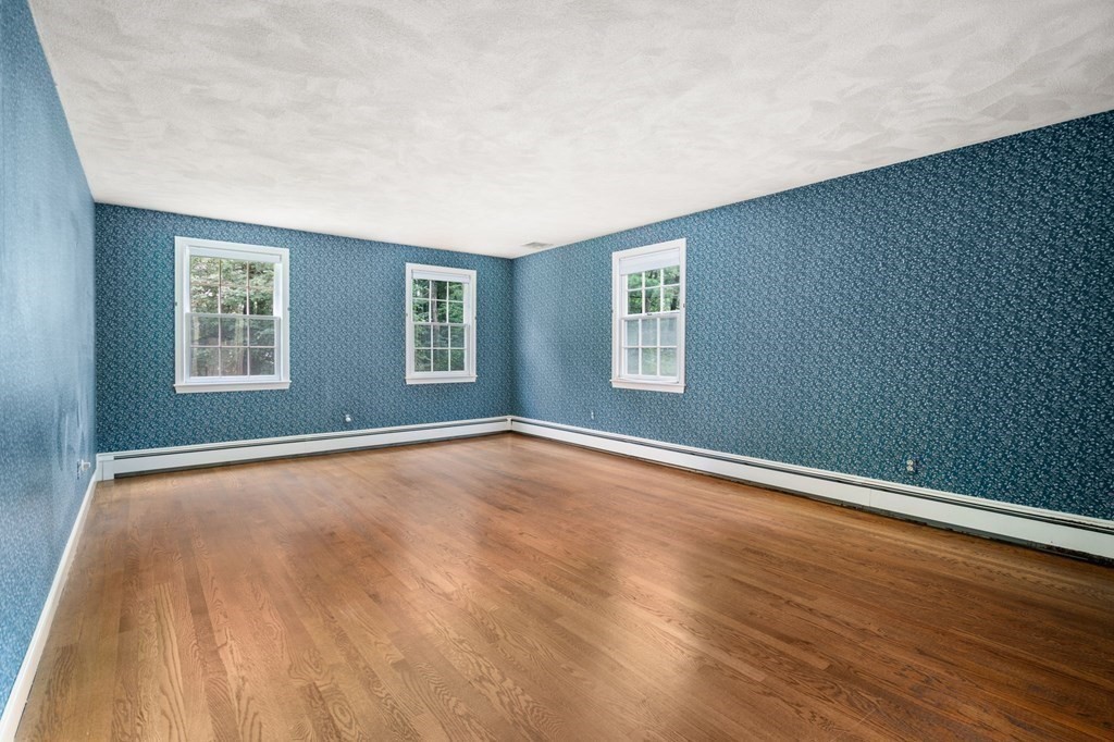 59 Spywood Road Sherborn, MA 01770 - Photo 15 of 40 an empty room with wooden floor and windows