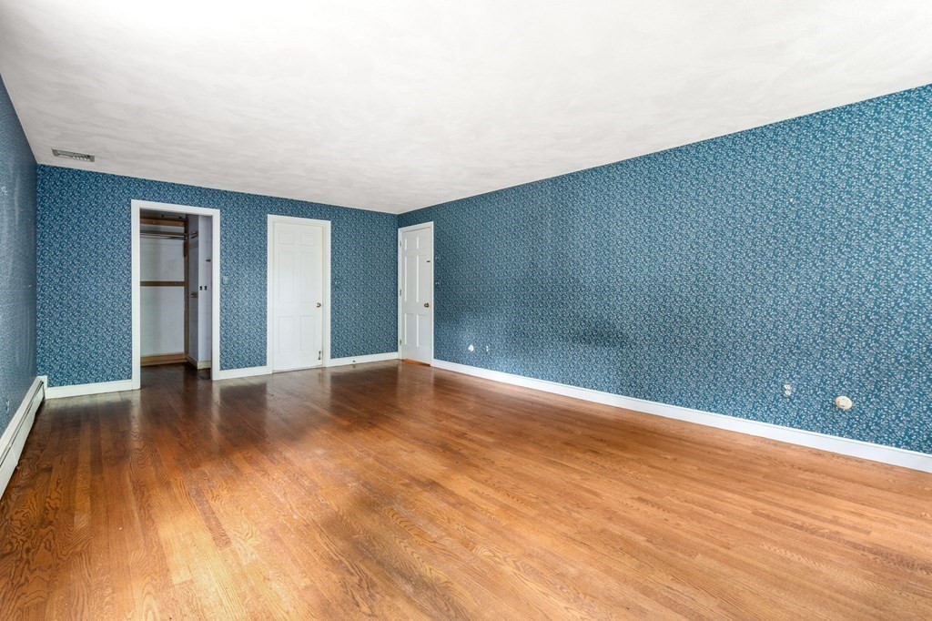 59 Spywood Road Sherborn, MA 01770 - Photo 16 of 40 a view of an empty room with wooden floor and a window