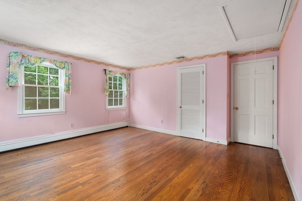 59 Spywood Road Sherborn, MA 01770 - Photo 20 of 40 an empty room with wooden floor and windows