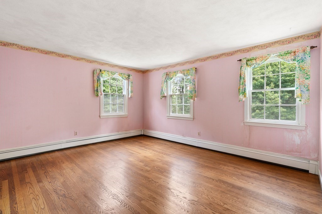 59 Spywood Road Sherborn, MA 01770 - Photo 21 of 40 a view of an empty room with wooden floor and a window