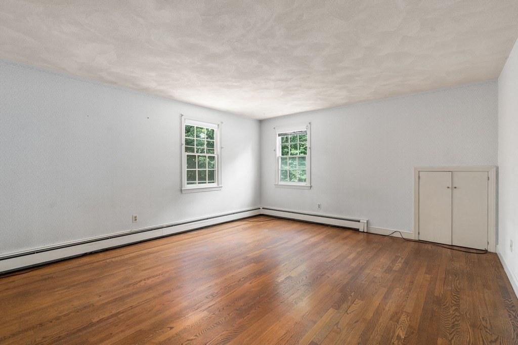 59 Spywood Road Sherborn, MA 01770 - Photo 22 of 40 a view of an empty room with wooden floor and a window
