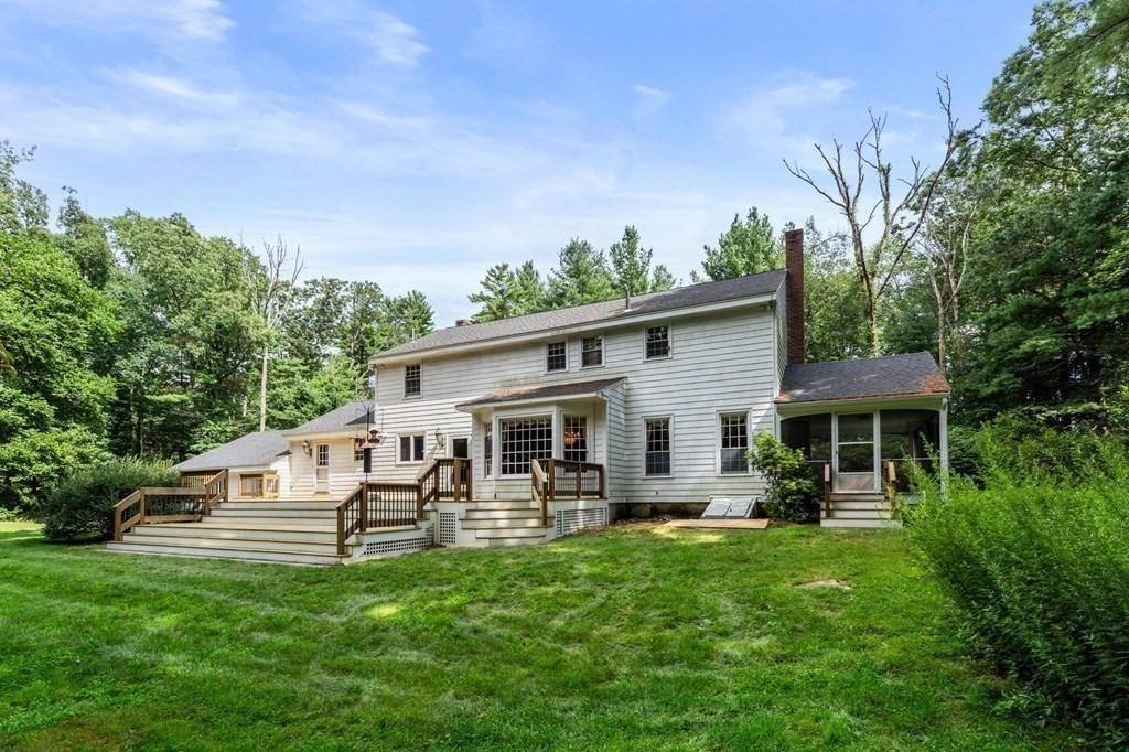59 Spywood Road Sherborn, MA 01770 - Photo 28 of 40 a backyard of a house with yard table and chairs