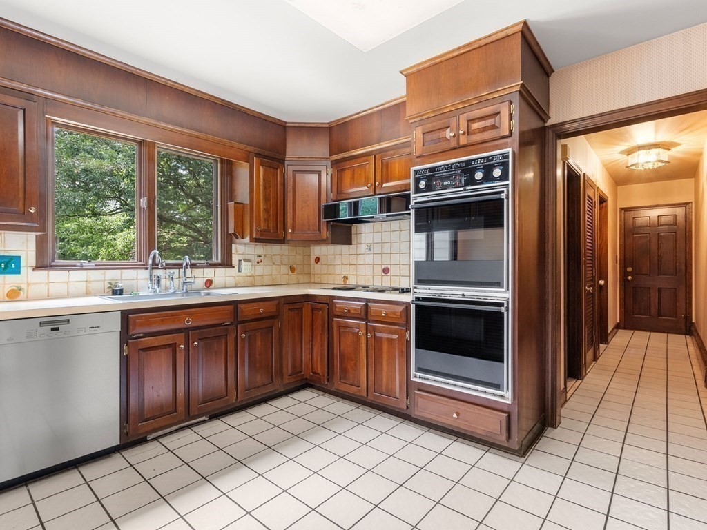 59 Spywood Road Sherborn, MA 01770 - Photo 4 of 40 a kitchen with stainless steel appliances granite countertop a stove a sink and a refrigerator
