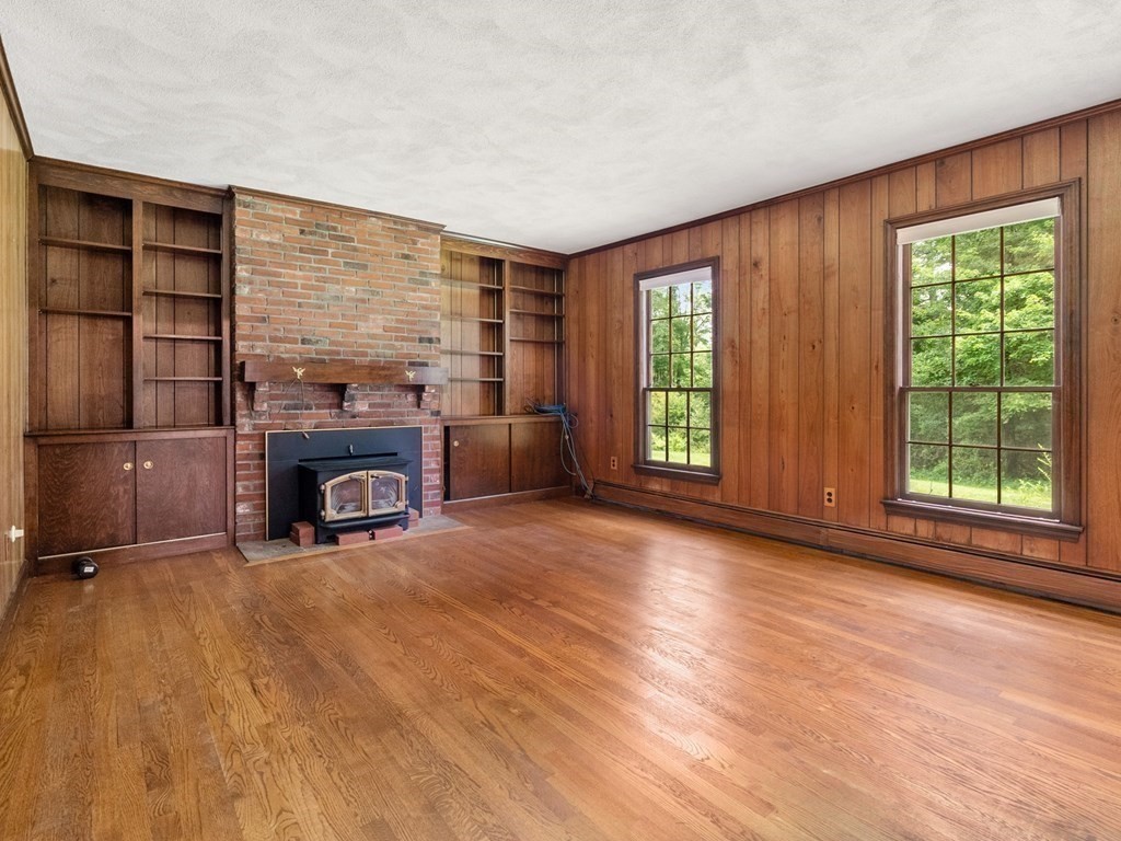 59 Spywood Road Sherborn, MA 01770 - Photo 5 of 40 an empty room with furniture and a fireplace