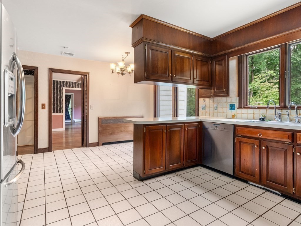 59 Spywood Road Sherborn, MA 01770 - Photo 8 of 40 a kitchen with stainless steel appliances a sink cabinets and wooden floor