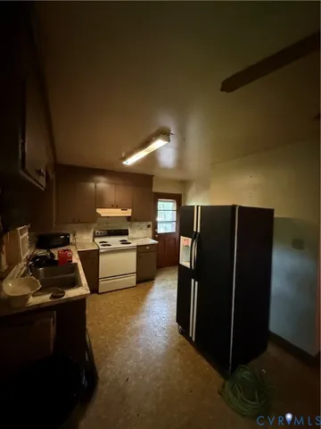 a kitchen with refrigerator and cabinets