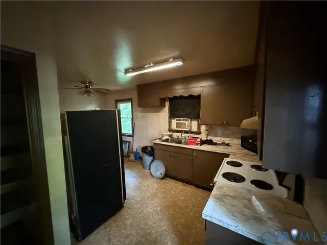 a kitchen with a refrigerator and a stove