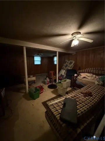 a living room with furniture gym equipment and a chandelier