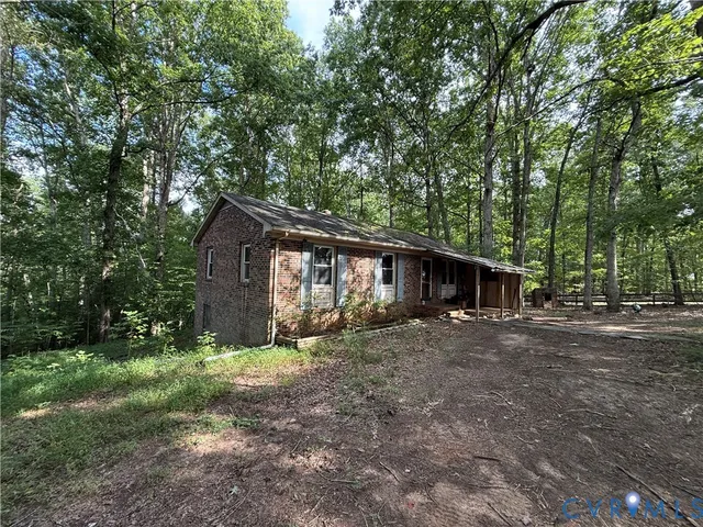 a wooden house with large trees and outdoor space