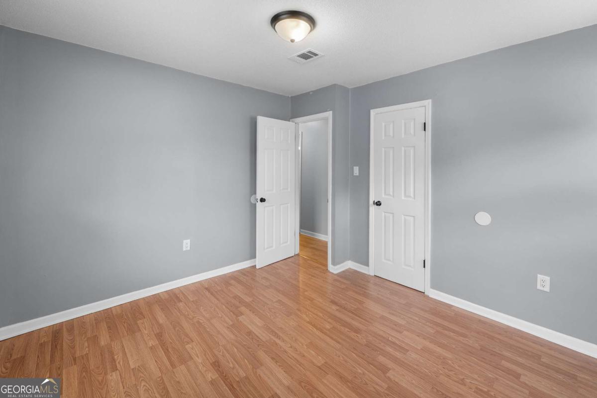 320 West Whatley Street Pooler, GA 31322 - Photo 15 of 34 wooden floor in an empty room with a window