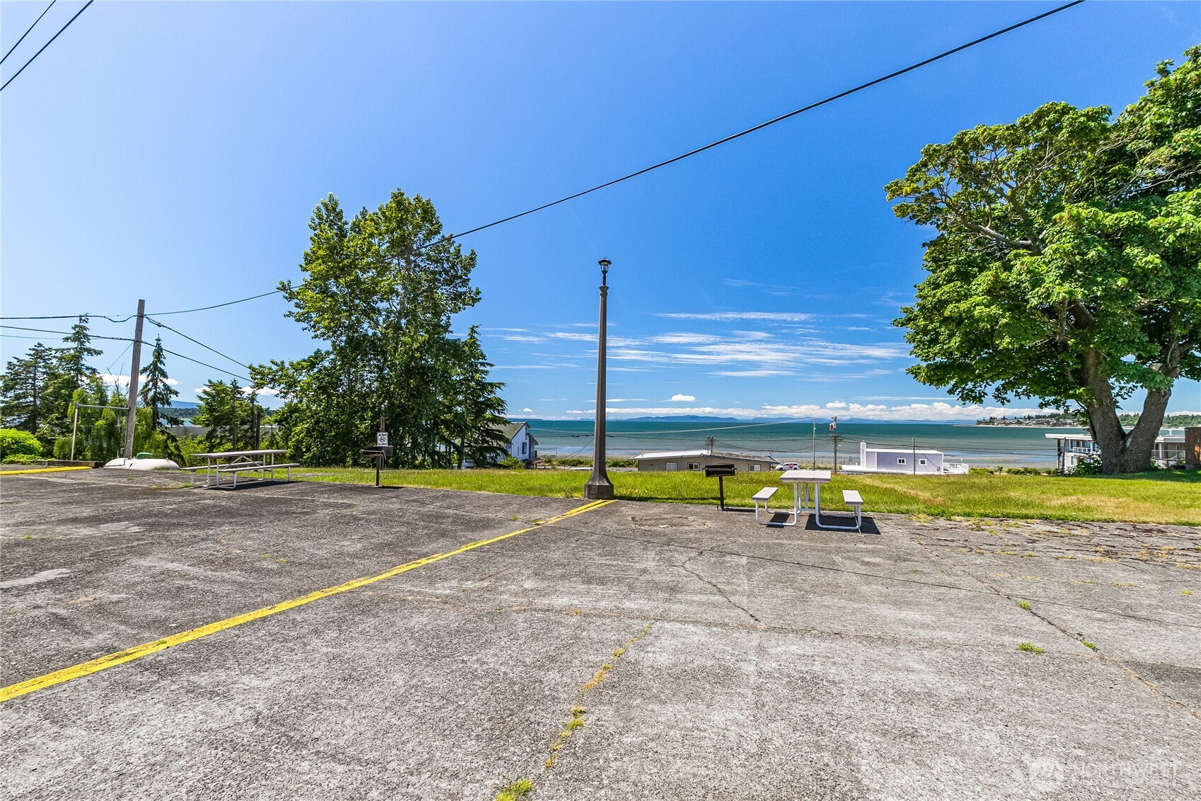 8080 Harborview Road, Unit 167 Blaine, WA 98230 - Photo 25 of 27 a view of a swimming pool with an outdoor space and seating area