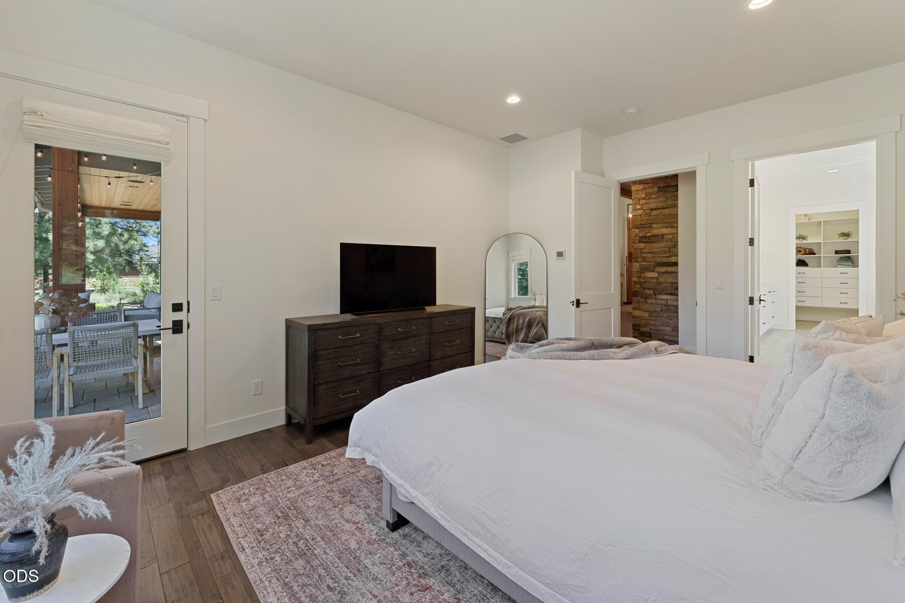 60255 Sunset View Drive Bend, OR 97702 - Photo 19 of 48 a bedroom with a bed and wooden floor