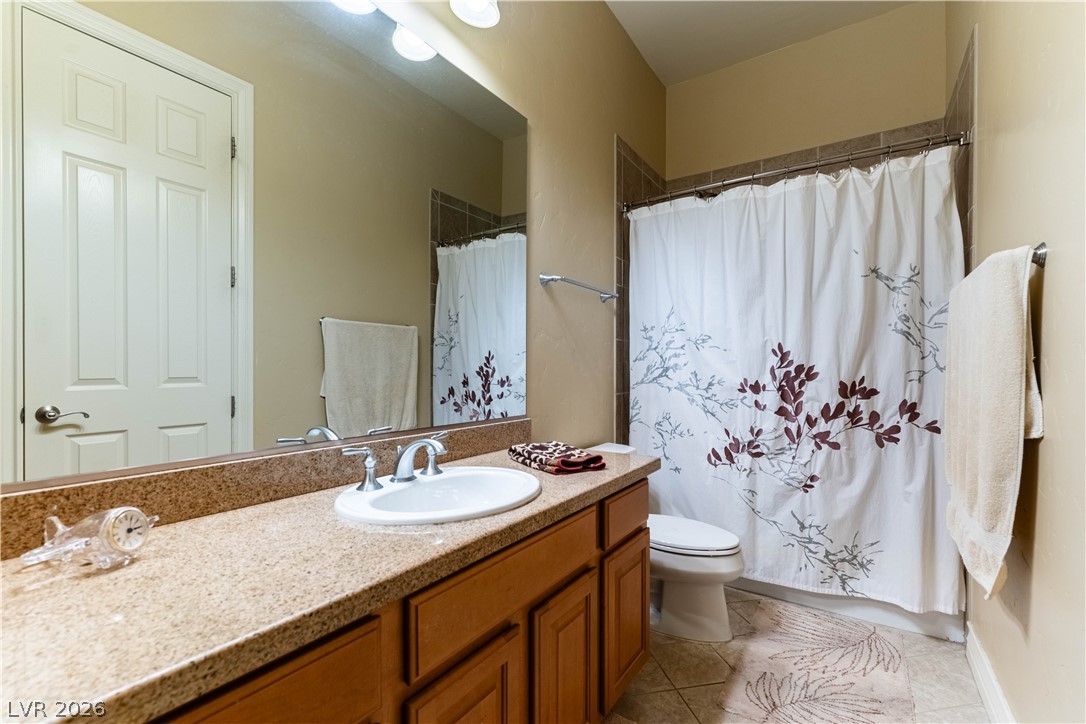 3661 Riley Ann Avenue Las Vegas, NV 89139 - Photo 22 of 42 A well-appointed bathroom offers a vanity with ample counter space and a classic shower-tub combination.